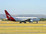 VH-OGJ roaring down the runway.